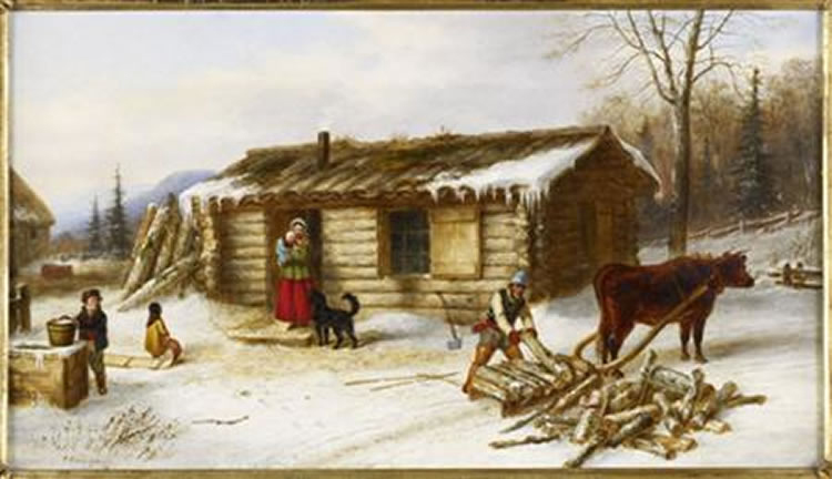 Chopping Logs Outside a Snow Covered Log Cabin